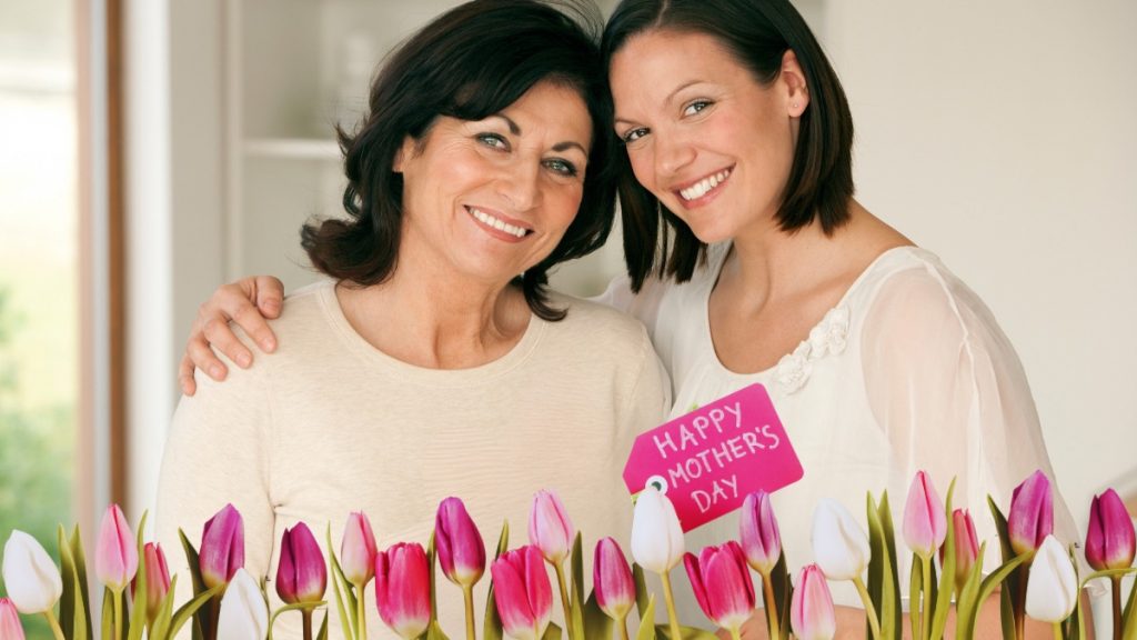 mother and daughter celebrating Mother's Day with tulips and gift card