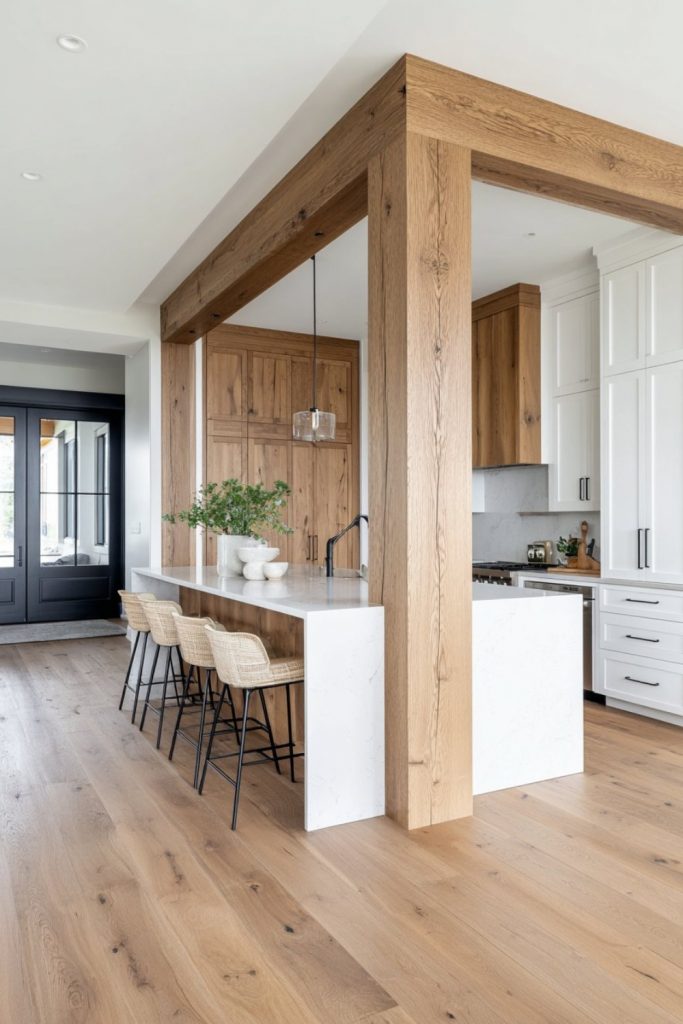 Modern kitchen design featuring a natural wood beam room divider and a white marble kitchen island with minimalist bar stools.